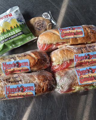 A variety of sandwiches arranged on a table, showcasing different fillings and bread types.