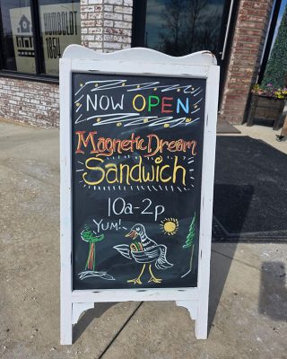 A sign displaying the text Magneto Dream Sandwich, likely advertising a unique sandwich offering.
