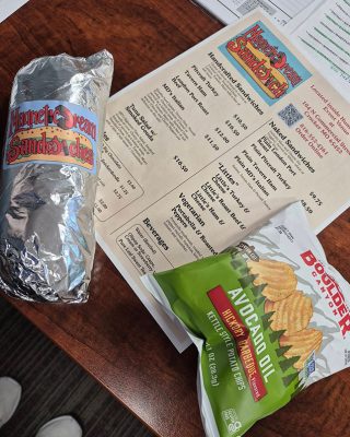 A table set with a bag of chips and a menu, suggesting a casual dining or snack experience.
